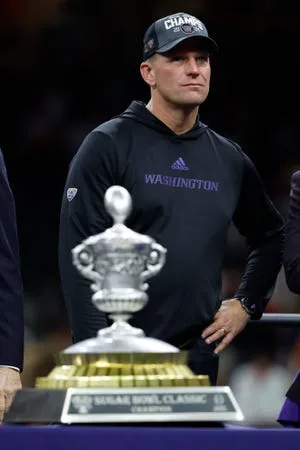 Kalen DeBoer stands on stage during the Sugar Bowl championship trophy presentation after Washington's loss at Texas.
